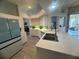 Bright kitchen with stainless steel sink and island with breakfast bar at 14334 Teasdale Ave, Hudson, FL 34667