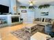 Comfortable living room featuring a tiled fireplace, neutral-toned furniture, and bright, natural light at 14334 Teasdale Ave, Hudson, FL 34667
