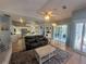 Open concept living room with tile floors, ceiling fan, and sliding glass doors to a screened-in patio at 14334 Teasdale Ave, Hudson, FL 34667