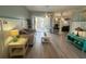 Light and bright living room with wood-look floors and sliding door to lanai at 14334 Teasdale Ave, Hudson, FL 34667