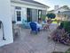 Paver patio with an outdoor seating area, lush landscaping, and an enclosed sunroom for comfortable outdoor living at 14334 Teasdale Ave, Hudson, FL 34667