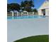 Community pool with fenced perimeter, lounge chairs, and clubhouse under a sunny sky at 14334 Teasdale Ave, Hudson, FL 34667