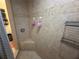 Shower featuring tiled walls, corner seat, built-in shelves and convenient towel rack at 14334 Teasdale Ave, Hudson, FL 34667