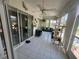 Bright sunroom with tile floor, ceiling fans and multiple sliding glass doors offering lots of light at 14334 Teasdale Ave, Hudson, FL 34667