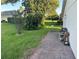 Serene outdoor space with lush grass, mature trees, and a paved patio perfect for relaxation and outdoor enjoyment at 14334 Teasdale Ave, Hudson, FL 34667