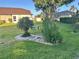 Well-maintained yard with lush green grass, decorative landscaping, and mature trees, creating a serene outdoor space at 14334 Teasdale Ave, Hudson, FL 34667