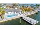 Waterfront home with modern pool, dock, and outdoor seating overlooking beautiful bay waters at 1493 Sea Gull S Dr, St Petersburg, FL 33707