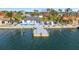 Enjoy this aerial view of the waterfront property featuring a private dock and pool, perfect for serene living and entertaining at 1493 Sea Gull S Dr, St Petersburg, FL 33707