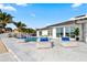 The backyard features a pool with contemporary lounge chairs, lush greenery, and a lovely view of the waterfront at 1493 Sea Gull S Dr, St Petersburg, FL 33707