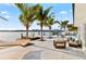 A relaxing outdoor patio with lounge seating, a hammock, pool, and a dock overlooking a beautiful bay at 1493 Sea Gull S Dr, St Petersburg, FL 33707