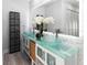 Stylish bathroom featuring dual vessel sinks, modern fixtures, and decorative wall mirror at 1493 Sea Gull S Dr, St Petersburg, FL 33707