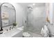 Bathroom featuring modern fixtures, decorative mirror, and glass shower at 1493 Sea Gull S Dr, St Petersburg, FL 33707
