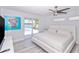 Bedroom with bright decor, ceiling fan, and sliding glass doors offering pool views at 1493 Sea Gull S Dr, St Petersburg, FL 33707