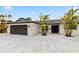 Beautifully remodeled home featuring a modern aesthetic, lovely landscaping, and a two-car garage at 1493 Sea Gull S Dr, St Petersburg, FL 33707