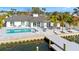 A waterfront home with a modern pool, dock, and seating area with bay view at 1493 Sea Gull S Dr, St Petersburg, FL 33707