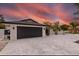Modern home featuring a large garage, sleek exterior, manicured landscaping, and an oversized parking area at 1493 Sea Gull S Dr, St Petersburg, FL 33707