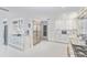 White kitchen with stainless steel appliances, custom cabinets, and a wine fridge at 1493 Sea Gull S Dr, St Petersburg, FL 33707