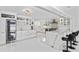 Spacious white kitchen featuring a wine fridge, bar seating, and modern countertops at 1493 Sea Gull S Dr, St Petersburg, FL 33707
