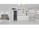 An open kitchen features a wine fridge, custom cabinets, and a marble fireplace at 1493 Sea Gull S Dr, St Petersburg, FL 33707
