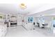 Modern kitchen with custom cabinets, stainless steel appliances, large marble island, and an adjacent dining area at 1493 Sea Gull S Dr, St Petersburg, FL 33707