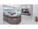 Bright living room with comfortable sofa, modern TV, and views of the canal at 1493 Sea Gull S Dr, St Petersburg, FL 33707