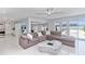 Open concept living room showcasing waterfront views, modern decor, and access to the kitchen and dining area at 1493 Sea Gull S Dr, St Petersburg, FL 33707