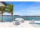 This waterfront home has a private dock, lounge chairs, and stunning views of the bay, perfect for relaxation and outdoor enjoyment at 1493 Sea Gull S Dr, St Petersburg, FL 33707