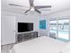 Bright bedroom with light-colored walls, wood floors, and sliding glass doors to a waterfront patio and pool at 1493 Sea Gull S Dr, St Petersburg, FL 33707