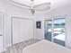 Bright bedroom with closet doors, light-colored walls, and sliding glass doors to a waterfront patio and pool at 1493 Sea Gull S Dr, St Petersburg, FL 33707