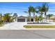 Well-maintained home with an attached garage, manicured lawn, and newly paved driveway at 1493 Sea Gull S Dr, St Petersburg, FL 33707