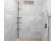 Modern shower featuring decorative tiling, shelving, and a handheld sprayer at 1493 Sea Gull S Dr, St Petersburg, FL 33707