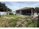 Backyard featuring a covered patio with a grassy area, perfect for outdoor activities at 1828 27Th N Ave, St Petersburg, FL 33713
