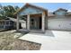 New construction home with a concrete driveway and covered porch at 1828 27Th N Ave, St Petersburg, FL 33713