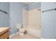 Bathroom featuring a toilet and a bathtub with a shower head, with tile on the wall at 19232 Barred Owl Ct, Land O Lakes, FL 34638