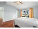 Bright bedroom featuring a large window and beautiful wood floors at 19232 Barred Owl Ct, Land O Lakes, FL 34638