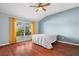 Cozy bedroom with natural light, vaulted ceiling, and wood floors at 19232 Barred Owl Ct, Land O Lakes, FL 34638