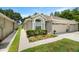 Charming home featuring a two-car garage, lovely landscaping and a manicured lawn at 19232 Barred Owl Ct, Land O Lakes, FL 34638