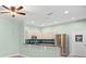 Kitchen with breakfast bar, stainless steel appliances, white cabinets, and modern lighting at 19232 Barred Owl Ct, Land O Lakes, FL 34638