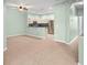 Bright open-concept living room that flows into a kitchen with stainless steel appliances at 19232 Barred Owl Ct, Land O Lakes, FL 34638