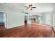 Open concept living room featuring beautiful wood floors, natural lighting, and neutral paint at 19232 Barred Owl Ct, Land O Lakes, FL 34638