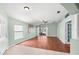 Bright living room with tile entry, wood floors, and sliding glass doors to the backyard at 19232 Barred Owl Ct, Land O Lakes, FL 34638