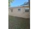 Exterior side view of home showing the backyard and windows at 1991 63Rd N Ave, St Petersburg, FL 33702
