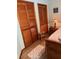 Cozy bedroom featuring wooden closets and floors, paired with a decorative area rug at 1991 63Rd N Ave, St Petersburg, FL 33702