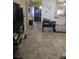 Hallway featuring tile floors, neutral decor, and seamless flow between living spaces at 1991 63Rd N Ave, St Petersburg, FL 33702