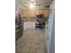 Functional kitchen featuring stainless steel appliances, ample storage, and easy-to-clean tile flooring at 1991 63Rd N Ave, St Petersburg, FL 33702