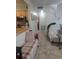 Functional kitchen, hallway, living room area with tile floors and casual seating at 1991 63Rd N Ave, St Petersburg, FL 33702