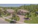 Aerial shot of a home with a large driveway and beautiful landscaping at 20142 Lace Cascade Rd, Land O Lakes, FL 34637