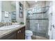Bathroom featuring a granite countertop vanity and a glass-enclosed tiled shower at 20142 Lace Cascade Rd, Land O Lakes, FL 34637