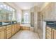 Bathroom with a dual sink vanity, soaking tub, and glass enclosed shower at 20142 Lace Cascade Rd, Land O Lakes, FL 34637