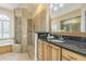 Elegant bathroom featuring a glass-enclosed shower, a luxurious bathtub, and a stylish vanity area at 20142 Lace Cascade Rd, Land O Lakes, FL 34637